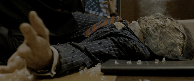 Wide shot frame from Constantine — room, table, hand