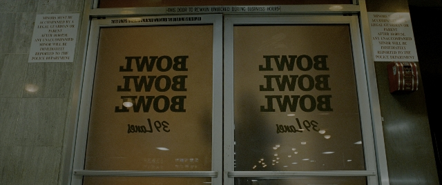 Wide shot frame from Constantine — room, door, glass