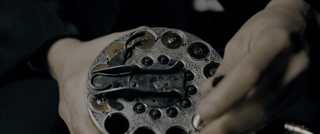 Wide shot frame from Constantine — suit, shirt, clock