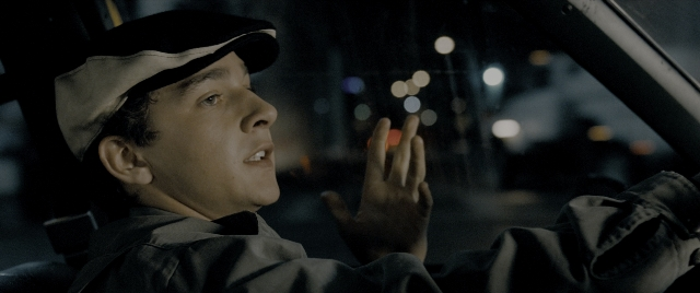 Wide shot frame from Constantine — sitting, street, hat