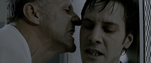 Wide shot frame from Constantine — room, shirt, face
