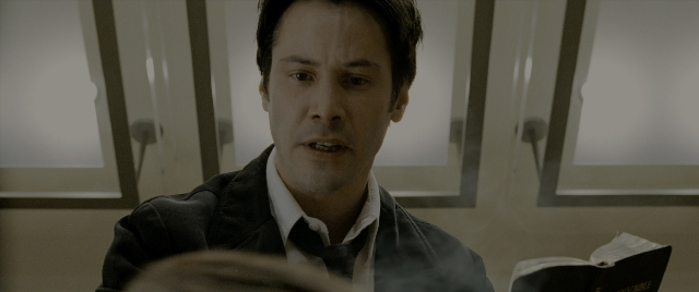 Medium shot frame from Constantine — sitting, book, room