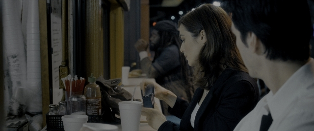 Wide shot frame from Constantine — sitting, table, dialogue