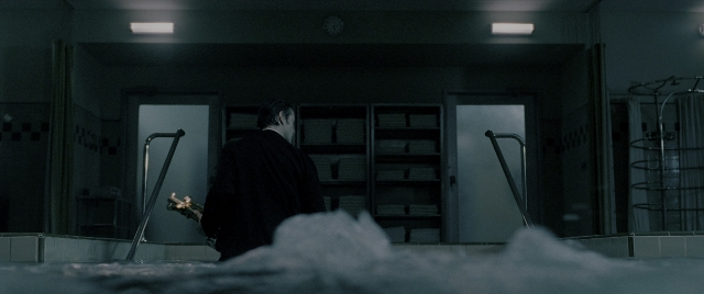 Wide shot frame from Constantine — standing, room, clock