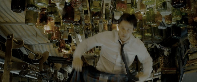 Wide shot frame from Constantine — standing, room, dialogue