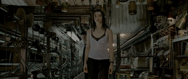 Wide shot frame from Constantine — standing, room, shirt