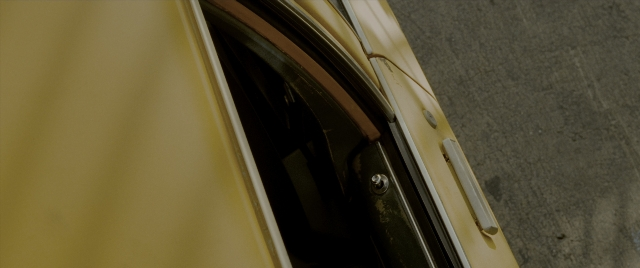 Wide shot frame from Constantine — door, car, window