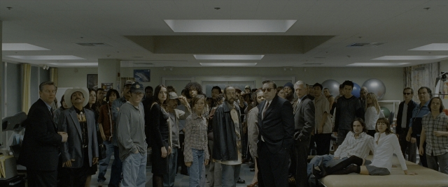 Wide shot frame from Constantine — standing, room, bed