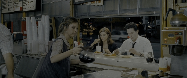 Wide shot frame from Constantine — sitting, dialogue, street