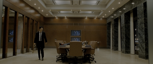 Wide shot frame from Constantine — walking, room, table