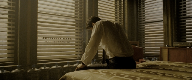 Medium shot frame from Constantine — sitting, room, table