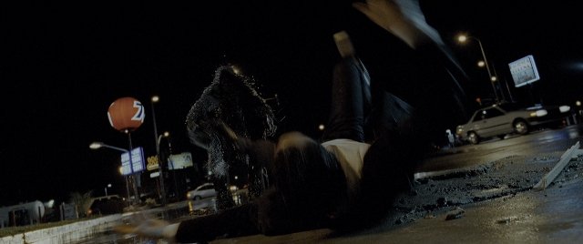 Wide shot frame from Constantine — street, night, wheel