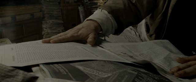 Frame from Constantine — sitting, room, newspaper