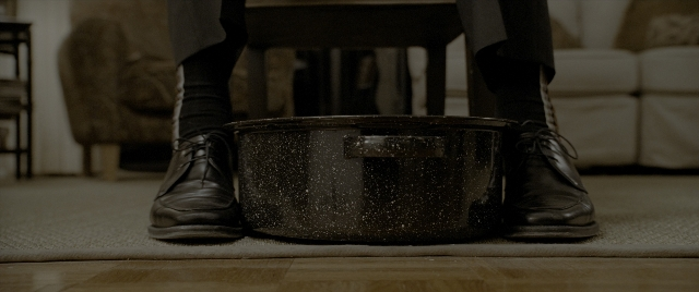 Wide shot frame from Constantine — standing, room, table