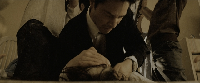 Wide shot frame from Constantine — sitting, room, bed