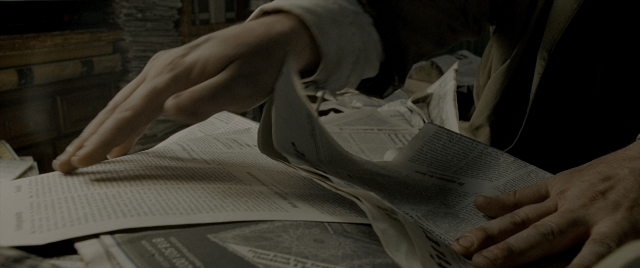Frame from Constantine — room, shirt, newspaper
