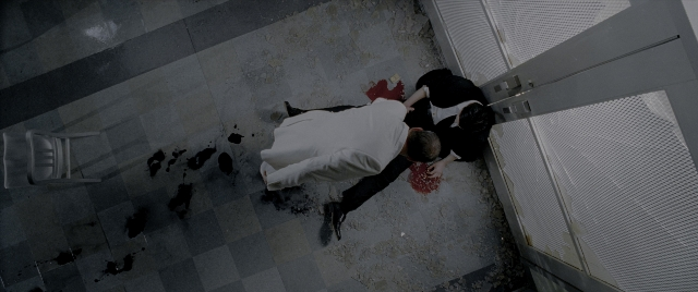 Wide shot frame from Constantine — door, shirt, chair