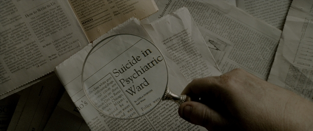 Wide shot frame from Constantine — book, hand, face