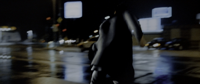 Wide shot frame from Constantine — walking, street, car