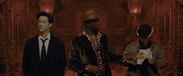 Wide shot frame from Constantine — standing, room, dialogue