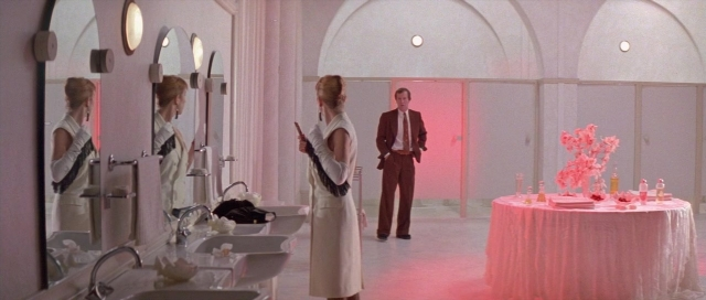 Wide shot frame from The Cook, the Thief, His Wife & Her Lover — standing, room, table