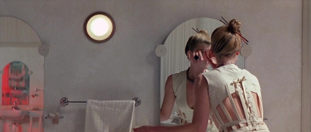 Frame from The Cook, the Thief, His Wife & Her Lover — standing, mirror, hand