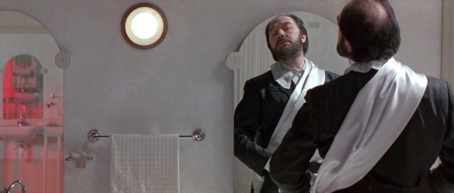 Wide shot frame from The Cook, the Thief, His Wife & Her Lover — standing, door, mirror