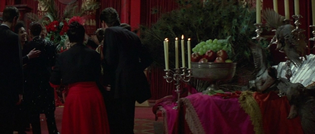 Wide shot frame from The Cook, the Thief, His Wife & Her Lover — standing, room, table