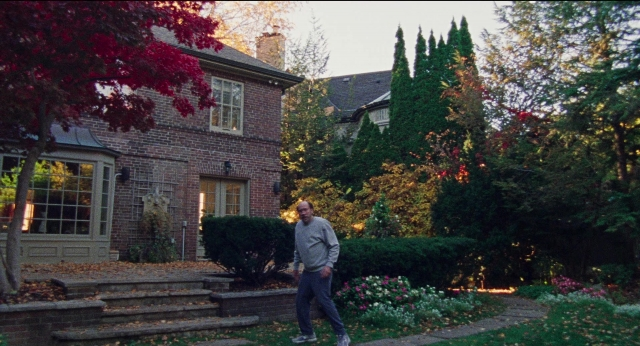 Wide shot frame from Dream Scenario — walking, house, person
