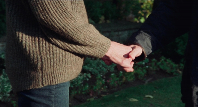 Wide shot frame from Dream Scenario — hand, person, trousers