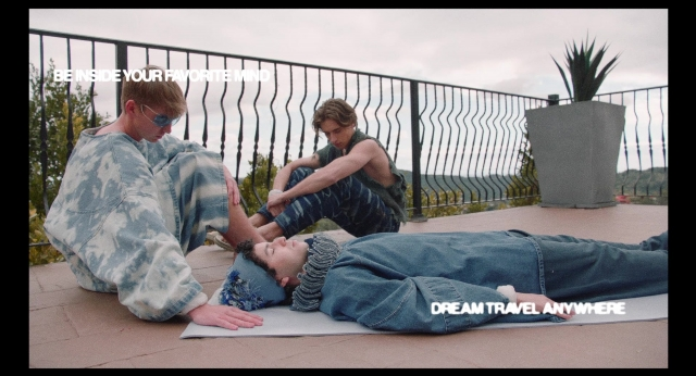 Wide shot frame from Dream Scenario — sitting, sea, person