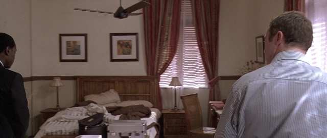 Wide shot frame from Hotel Rwanda — standing, room, dialogue