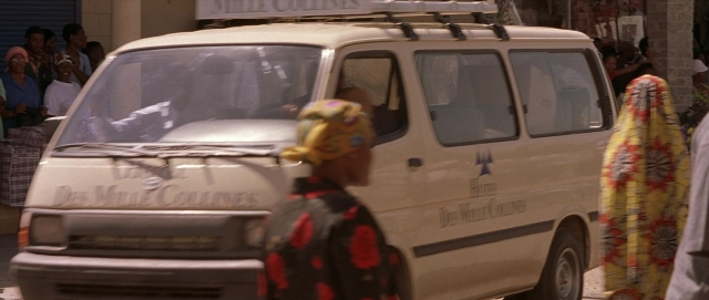Wide shot frame from Hotel Rwanda — sitting, walking, street