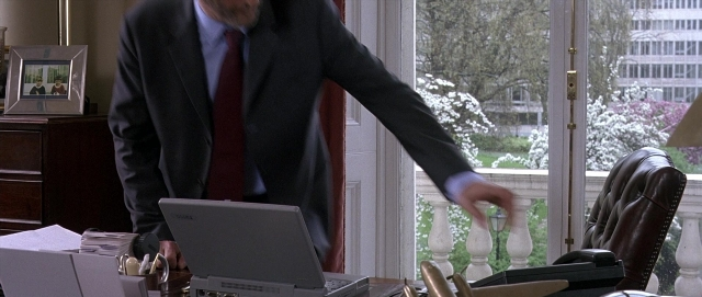 Wide shot frame from Hotel Rwanda — standing, phone, hand