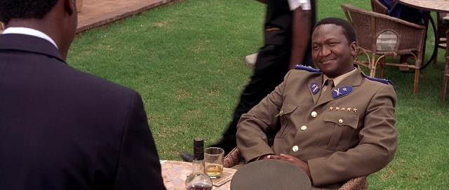 Wide shot frame from Hotel Rwanda — sitting, table, dialogue