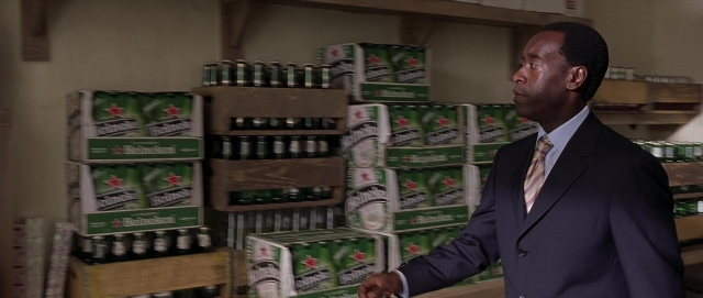 Wide shot frame from Hotel Rwanda — standing, suit, tie