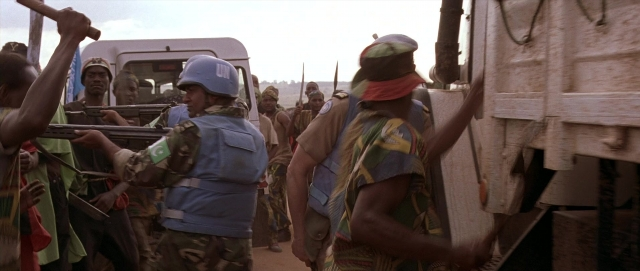 Wide shot frame from Hotel Rwanda — standing, street, person