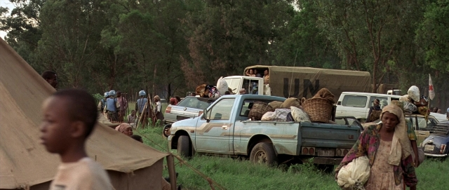 Wide shot frame from Hotel Rwanda — sitting, standing, walking