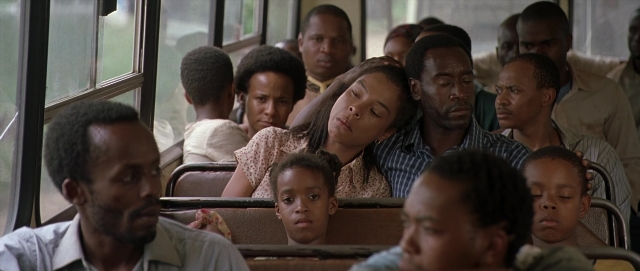 Wide shot frame from Hotel Rwanda — sitting, bus, person