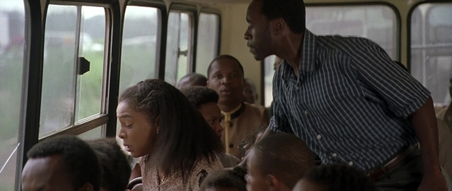 Wide shot frame from Hotel Rwanda — standing, street, shirt