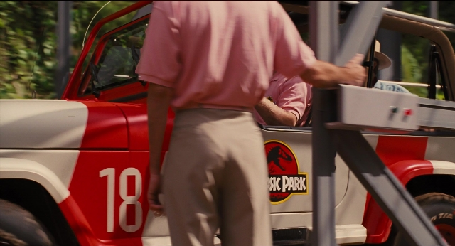 Wide shot frame from Jurassic Park — standing, bed, street