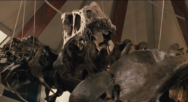 Wide shot frame from Jurassic Park — dinosaur, skull, window
