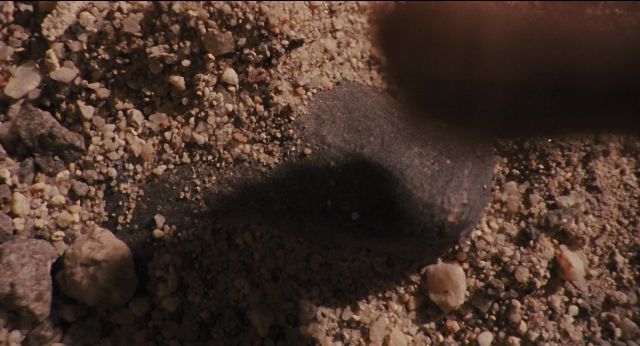 Wide shot frame from Jurassic Park — bed, animal