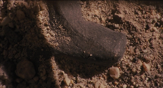Wide shot frame from Jurassic Park — bed, animal
