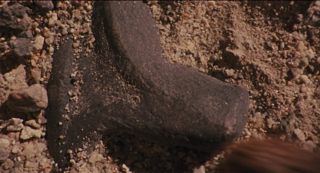 Wide shot frame from Jurassic Park — bed, animal