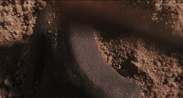 Wide shot frame from Jurassic Park — bed, footwear