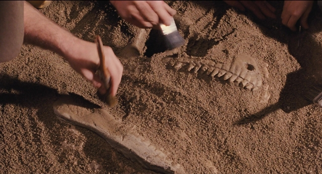 Frame from Jurassic Park — bed, person, human hand