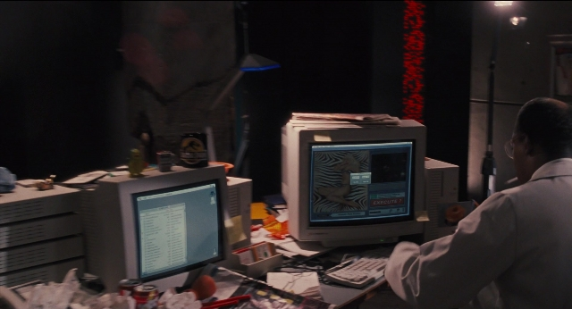 Wide shot frame from Jurassic Park — sitting, shirt, office