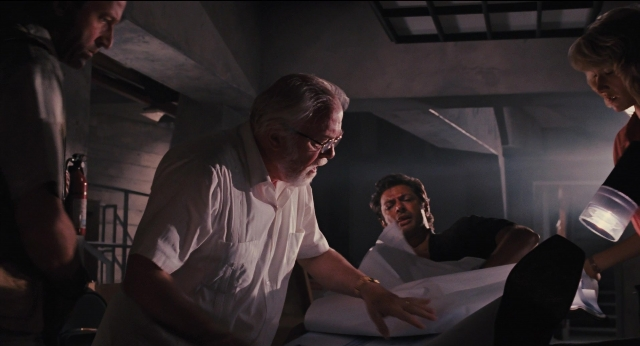 Wide shot frame from Jurassic Park — sitting, room, bed