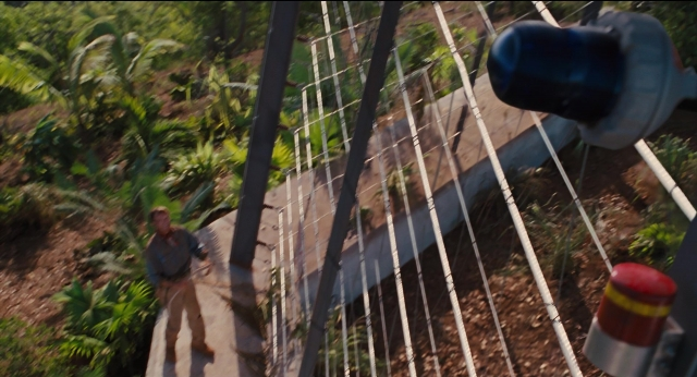 Wide shot frame from Jurassic Park — walking, shirt, forest